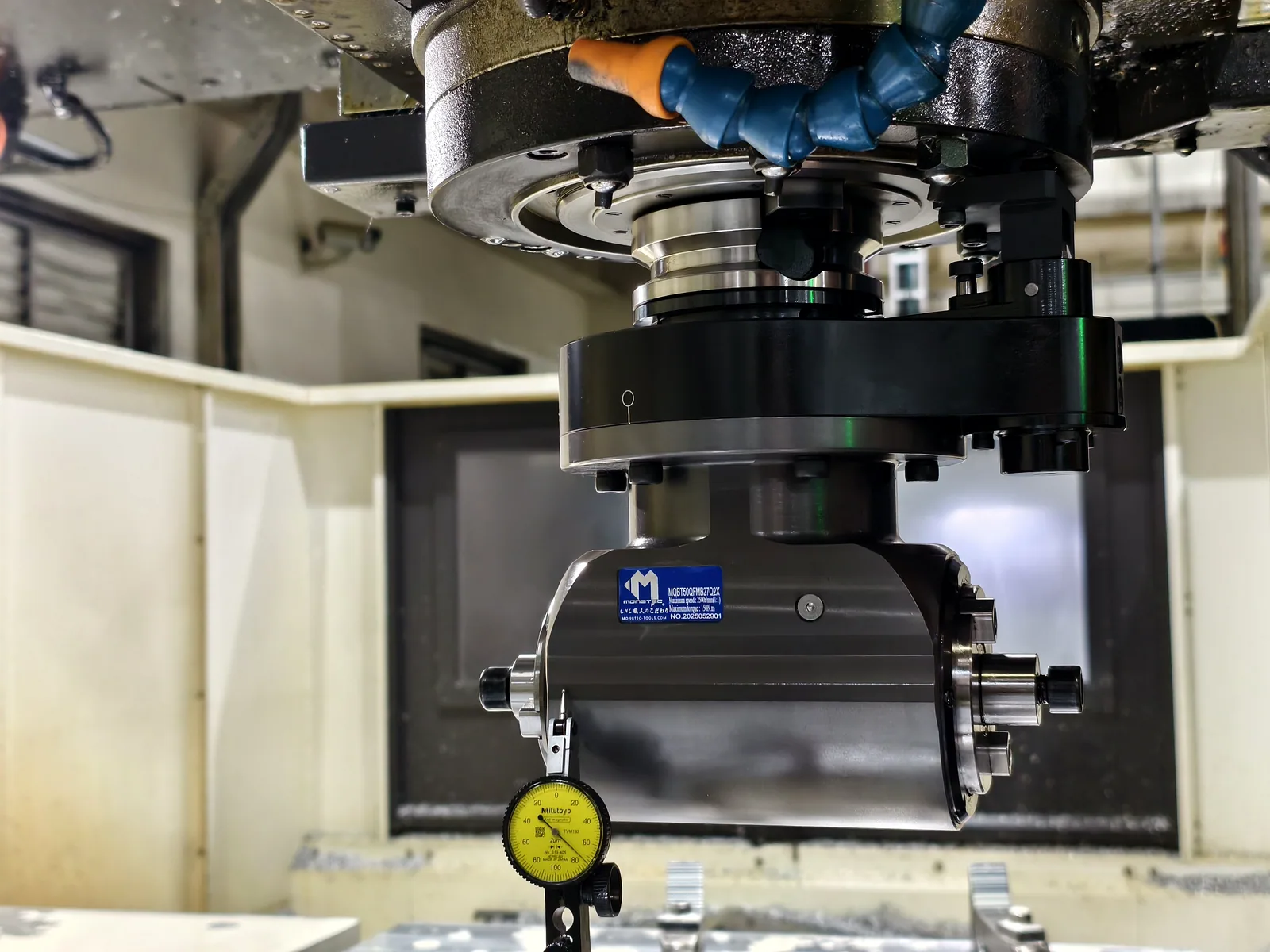 Runout of a Mongtec angle head checked with a dial indicator in the machine