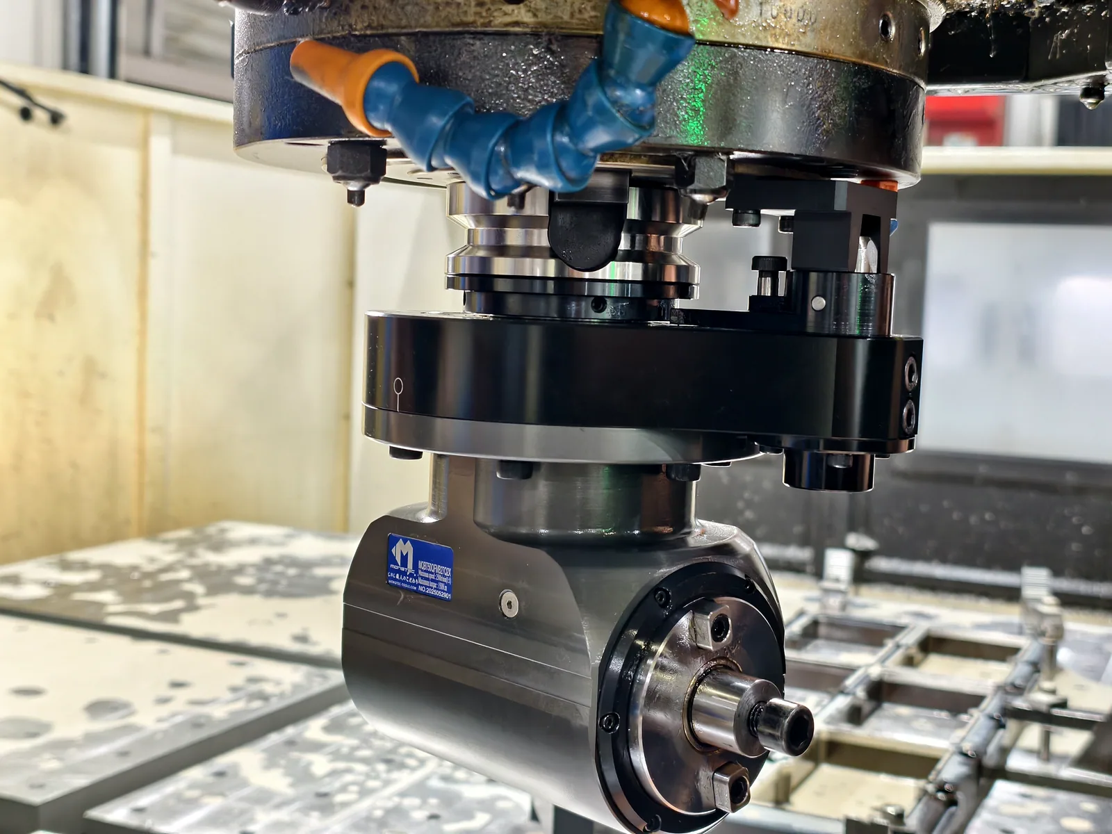 Mongtec angle head positioned for side machining on a fixture plate
