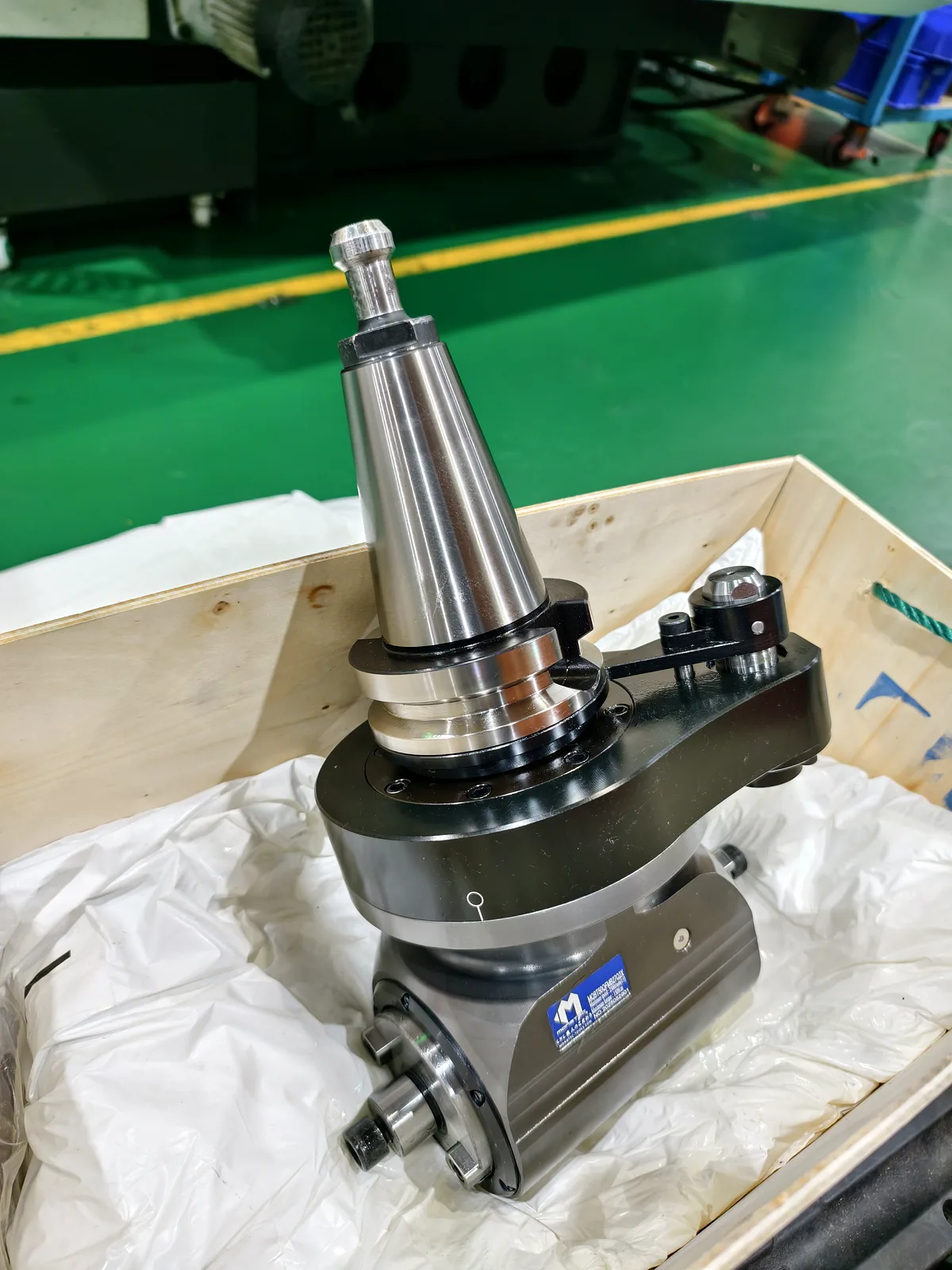 Mongtec angle head unpacked at a machine shop before installation